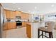 Bright kitchen with granite countertops, stainless steel appliances, and bar seating at 7564 Marker Ave, Kissimmee, FL 34747
