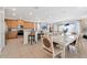 Open-concept kitchen and dining area with bar seating and stainless steel appliances at 7564 Marker Ave, Kissimmee, FL 34747
