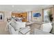 Open-concept living room featuring modern furnishings, a large TV, and a seamless flow to the kitchen at 7564 Marker Ave, Kissimmee, FL 34747
