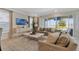 Inviting living room boasts comfortable seating, large windows with backyard pool view, and stylish decor at 7564 Marker Ave, Kissimmee, FL 34747