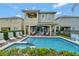 Backyard featuring a private pool and spa, covered patio, and outdoor seating, perfect for entertaining at 7564 Marker Ave, Kissimmee, FL 34747