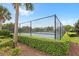 Community tennis court surrounded by lush greenery, perfect for active residents seeking exercise and recreation at 7564 Marker Ave, Kissimmee, FL 34747