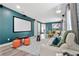 Home theater room features projector, large screen, comfortable seating, and contemporary decor at 7564 Marker Ave, Kissimmee, FL 34747