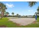 Two sand volleyball courts sit side-by-side on a green lawn, ready for a friendly neighborhood match at 7564 Marker Ave, Kissimmee, FL 34747