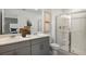 Modern bathroom featuring double vanity, shower with glass door, and neutral color palette at 7751 Waterscape Dr, Groveland, FL 34736