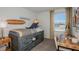 A bright bedroom with unique artwork, a surfboard wall decor, and a desk at 7751 Waterscape Dr, Groveland, FL 34736