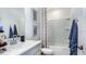 Bright bathroom with a vanity, mirror, toilet, and a shower/tub with patterned curtain at 7757 Waterscape Dr, Groveland, FL 34736
