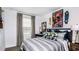 Comfortable bedroom with stylish decor, a workspace, and a window with blinds for natural light at 7757 Waterscape Dr, Groveland, FL 34736