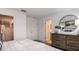 Comfortable bedroom with walk-in closet, dresser, and mirror at 7757 Waterscape Dr, Groveland, FL 34736