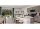 Modern kitchen with island, stainless steel appliances, and sliding glass doors to patio at 7757 Waterscape Dr, Groveland, FL 34736