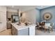 Chic kitchen with island, stainless steel appliances, and adjacent dining area at 7757 Waterscape Dr, Groveland, FL 34736