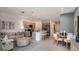 Open concept living space featuring a modern kitchen, cozy seating area, and dining space at 7757 Waterscape Dr, Groveland, FL 34736