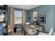 Home office featuring a large window, blue walls, and modern desk at 7757 Waterscape Dr, Groveland, FL 34736