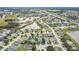 A high angle showcases a neighborhood with varied home styles, mature trees, and community waterways at 7905 Golden Pond Cir, Kissimmee, FL 34747