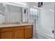 This bathroom has a shower-tub combo with a sliding door and granite vanity at 7905 Golden Pond Cir, Kissimmee, FL 34747