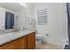 This bathroom has a shower-tub combo with a curtain, granite vanity and white toilet at 7905 Golden Pond Cir, Kissimmee, FL 34747