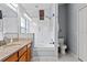 This bathroom has a shower-tub combo with a sliding door, granite vanity and white toilet at 7905 Golden Pond Cir, Kissimmee, FL 34747