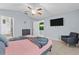 Bright bedroom with ceiling fan, walk-in closet, en suite bathroom and tile floors at 7905 Golden Pond Cir, Kissimmee, FL 34747