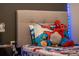 Whimsical bedroom with colorful superhero-themed bedding and playful decor, sparking imagination at 7905 Golden Pond Cir, Kissimmee, FL 34747