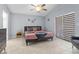 This primary bedroom has a ceiling fan, king size bed, and a sunny window at 7905 Golden Pond Cir, Kissimmee, FL 34747