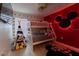 Charming bedroom featuring a playful Mickey Mouse theme, bunkbeds, and a cozy teepee tent at 7905 Golden Pond Cir, Kissimmee, FL 34747