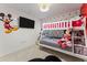 Adorable bedroom featuring a bunk bed, cartoon character decor and tile floors at 7905 Golden Pond Cir, Kissimmee, FL 34747