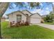 Charming single-story home with a well-manicured lawn, two car garage, and inviting curb appeal at 7905 Golden Pond Cir, Kissimmee, FL 34747