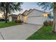 Charming single-story home with a well-manicured lawn, two car garage, and inviting curb appeal at 7905 Golden Pond Cir, Kissimmee, FL 34747