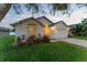 Charming single-story home with a well-manicured lawn, two car garage, and inviting curb appeal at 7905 Golden Pond Cir, Kissimmee, FL 34747