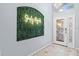 Welcoming foyer features decorative front door, stylish tile flooring, and a unique green accent wall at 7905 Golden Pond Cir, Kissimmee, FL 34747