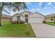 Charming single-story home with a well-manicured lawn and attached two-car garage at 7905 Golden Pond Cir, Kissimmee, FL 34747
