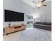 Cozy living room with vaulted ceiling, modern furniture, natural light and tile floors at 7905 Golden Pond Cir, Kissimmee, FL 34747