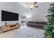 Spacious living room with vaulted ceilings, a large TV, and comfortable gray sofa at 7905 Golden Pond Cir, Kissimmee, FL 34747