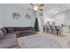 Open-concept living room featuring a comfortable gray sectional sofa and a view of the kitchen at 7905 Golden Pond Cir, Kissimmee, FL 34747