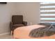 Inviting main bedroom showcasing a cozy armchair and tranquil ambiance with natural light at 7905 Golden Pond Cir, Kissimmee, FL 34747