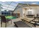 Enjoy the screened-in pool, lounge chairs, and dining area, perfect for outdoor living at 7905 Golden Pond Cir, Kissimmee, FL 34747