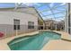 Sparkling screened-in pool with surrounding patio, offering a refreshing escape and outdoor entertainment space at 7905 Golden Pond Cir, Kissimmee, FL 34747