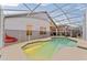 Enclosed pool with a screened enclosure and concrete patio area at 7905 Golden Pond Cir, Kissimmee, FL 34747