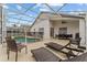 Inviting screened-in pool area with comfortable lounge chairs and outdoor dining set, perfect for relaxation at 7905 Golden Pond Cir, Kissimmee, FL 34747