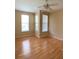 Bedroom featuring wood floors, two windows, base trim, and a ceiling fan with lighting at 860 N Orange Ave # 428, Orlando, FL 32801