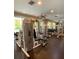 Community gym featuring various exercise machines, mirrors, and a ceiling fan for a complete workout space at 860 N Orange Ave # 428, Orlando, FL 32801