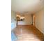 Living room featuring an open floor plan and wood floors; view of the kitchen and adjacent built-in shelving at 860 N Orange Ave # 428, Orlando, FL 32801