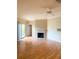 Living room featuring wood floors, sliding glass doors to the balcony, an air conditioner, and a fireplace at 860 N Orange Ave # 428, Orlando, FL 32801