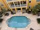 Bird's eye view of a community swimming pool at a multi-story apartment complex with an yellow facade at 860 N Orange Ave # 428, Orlando, FL 32801