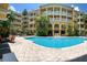 Beautiful swimming pool with sun loungers at a multi-story residential apartment complex with lush landscaping at 860 N Orange Ave # 428, Orlando, FL 32801