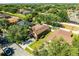 Aerial view of a home with mature trees, lush green landscaping, driveway, and neighboring houses at 1007 Golf View Estates Dr, Orange City, FL 32763