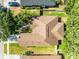 Aerial view of the home and surrounding landscape featuring a large roof at 1007 Golf View Estates Dr, Orange City, FL 32763