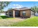 A partial view of the backyard, with a screened patio and adjacent yard at 1007 Golf View Estates Dr, Orange City, FL 32763