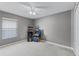 Spacious bedroom with neutral walls, two arcade game machines, and a ceiling fan at 1007 Golf View Estates Dr, Orange City, FL 32763