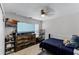 Comfortable bedroom with a dark blue bedspread, wooden dresser, and organized shelving at 1007 Golf View Estates Dr, Orange City, FL 32763